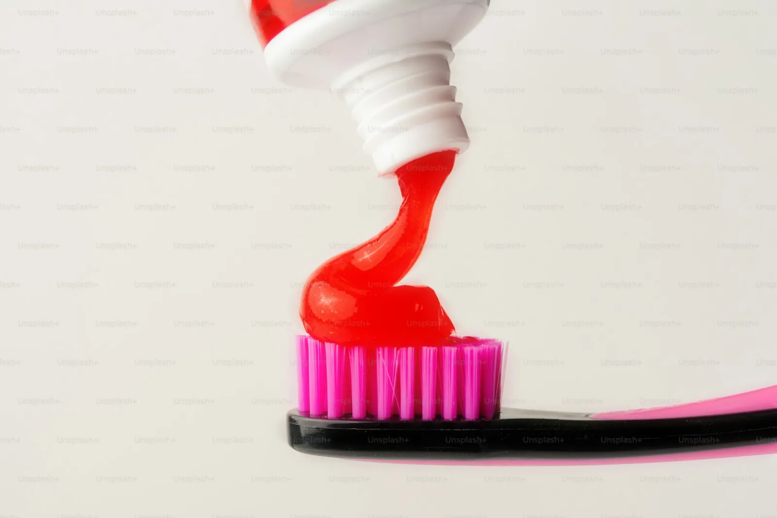 Toothpaste on a brush — a minimalist shot on a light background